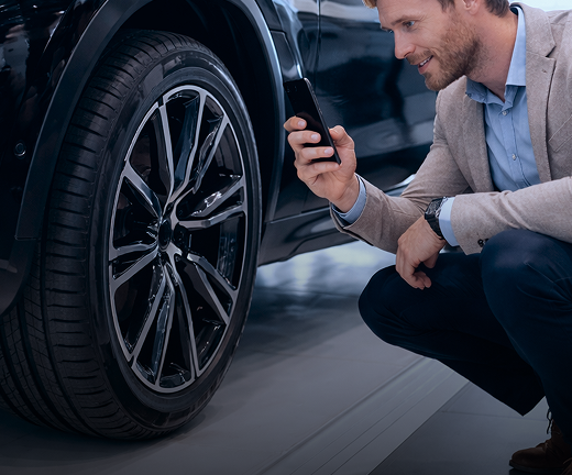Man scanning tire DOT with a phone on an angle