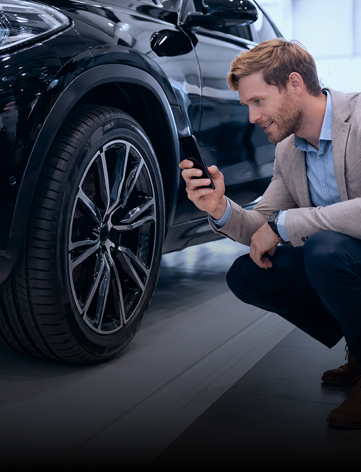 Man scanning tire DOT with a phone on an angle
