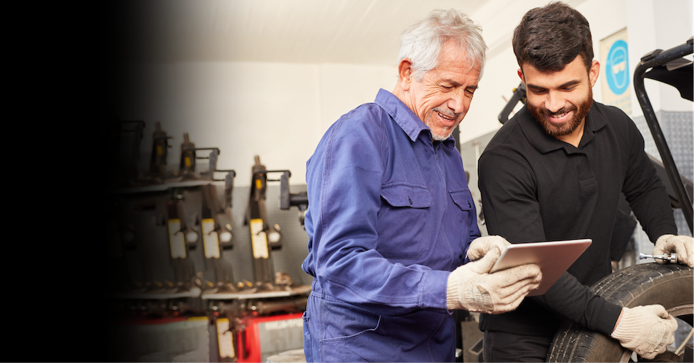 tire technicians scanning a tire with a mobile device