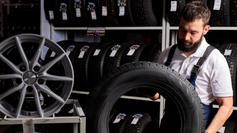 man scanning tires in a tire warehouse