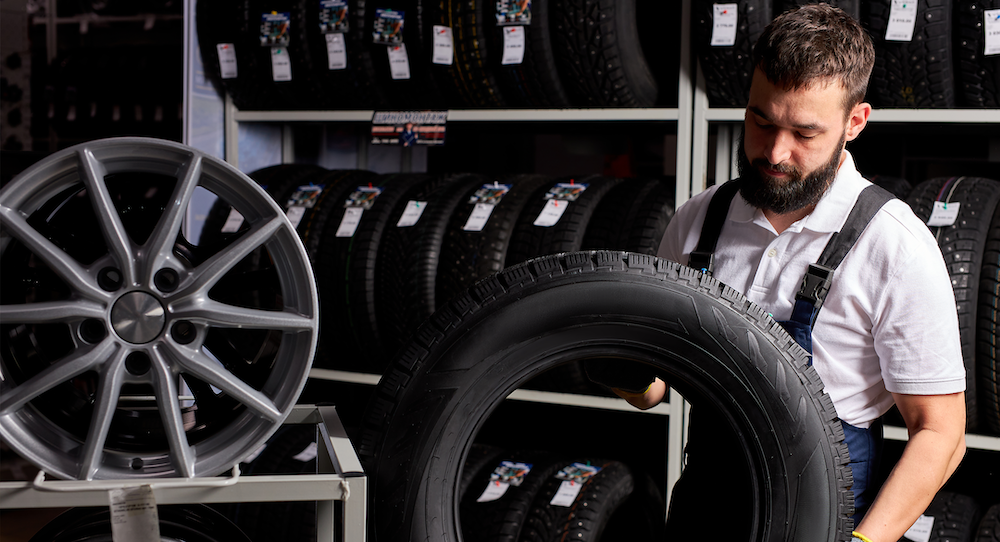 man scanning tires in a tire warehouse