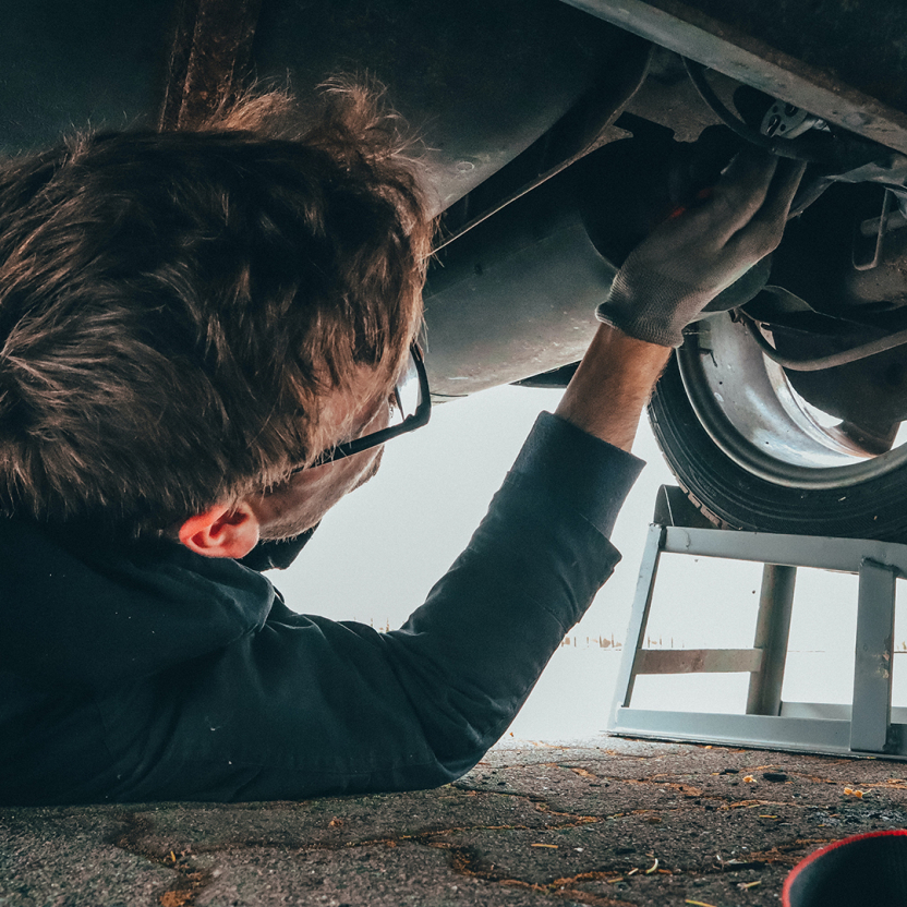 A mechanic works on a car