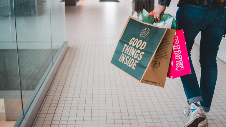 man walking with shopping bags