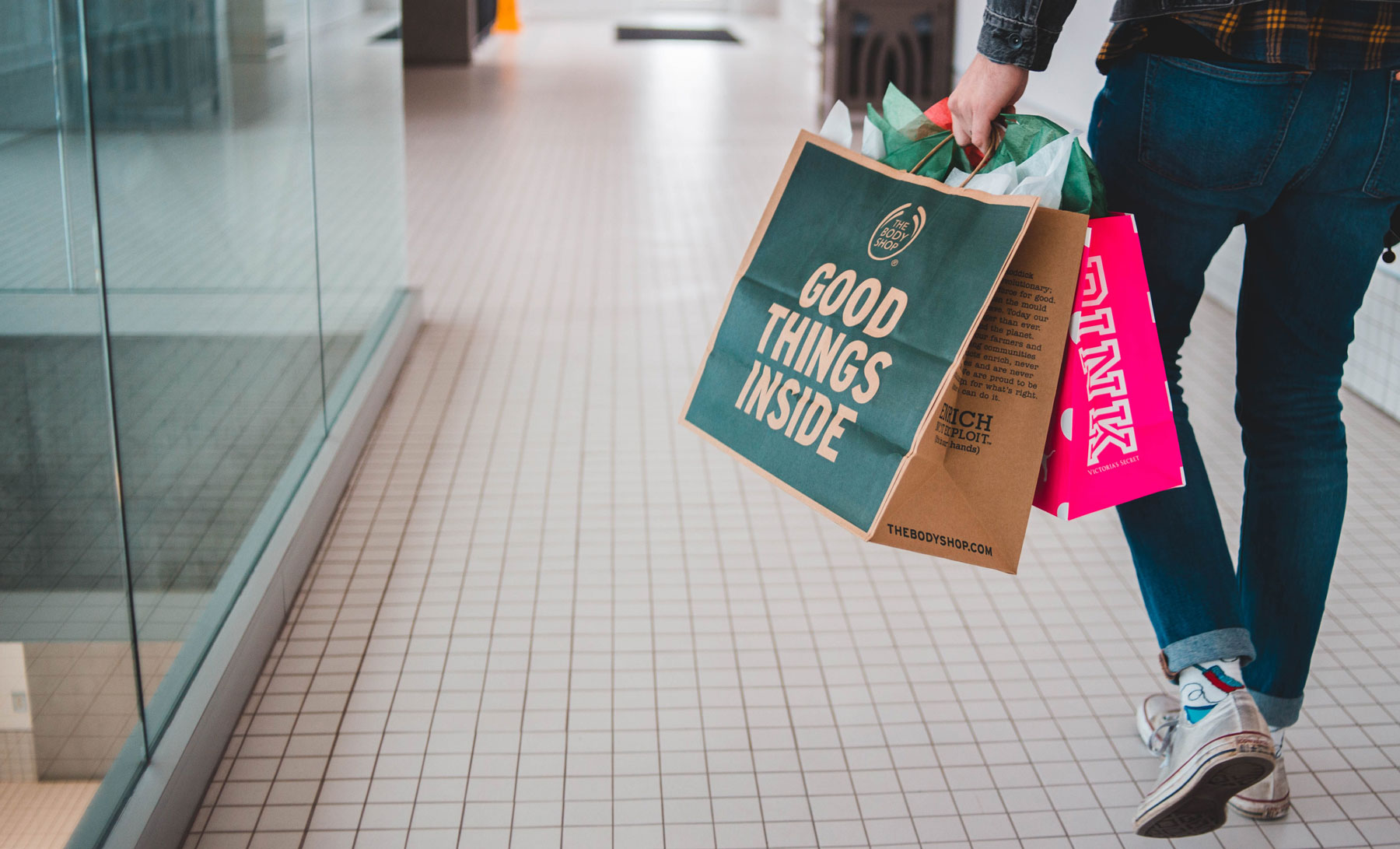 man walking with shopping bags