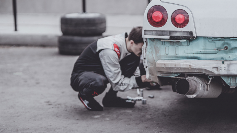 technician working on a corvette tire