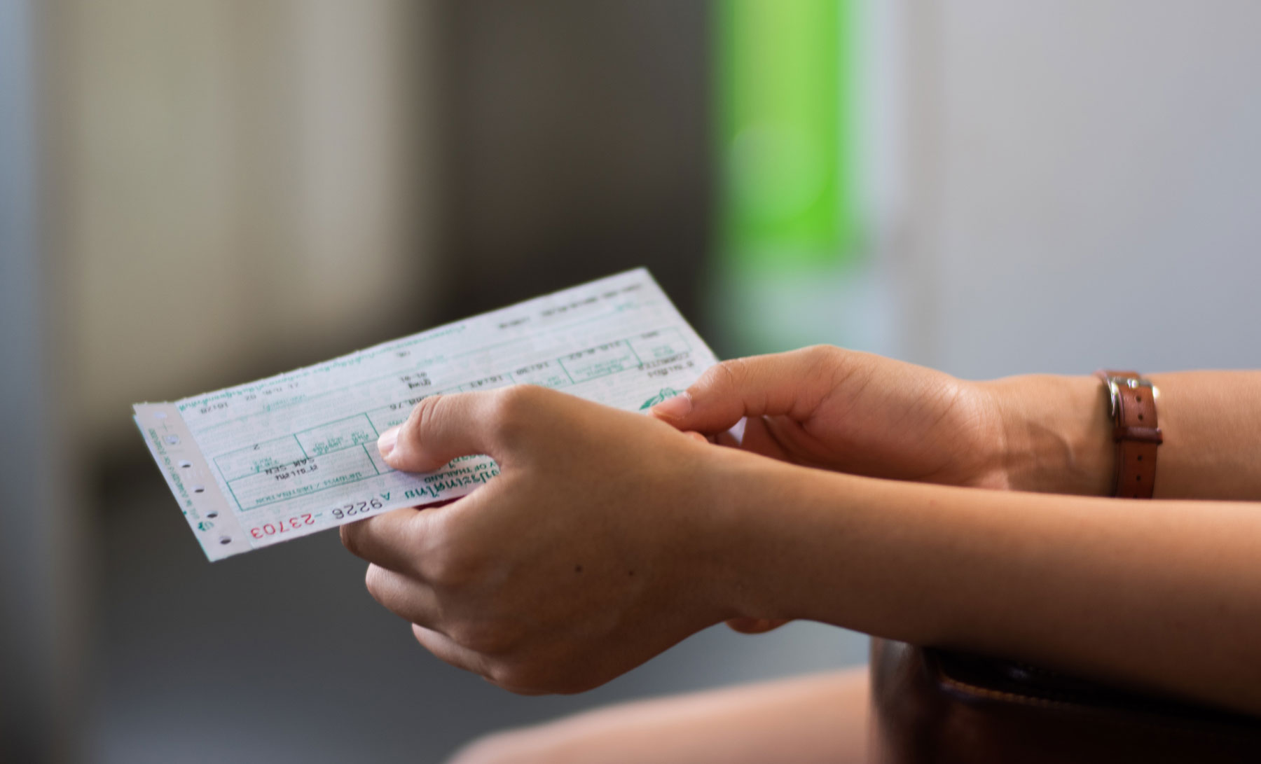 woman holding a train ticket