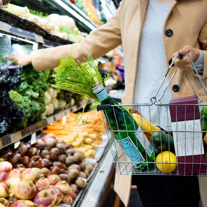 woman picking vegetables in a supermarket