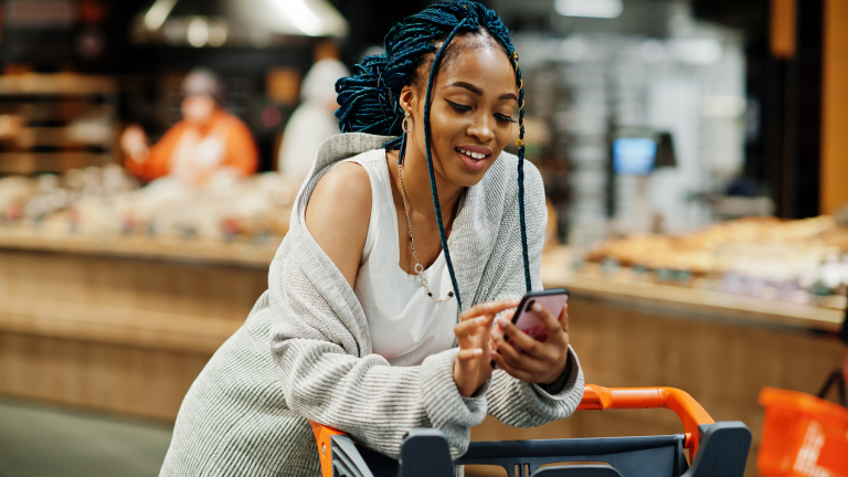 woman in a convenience store on her cell phone