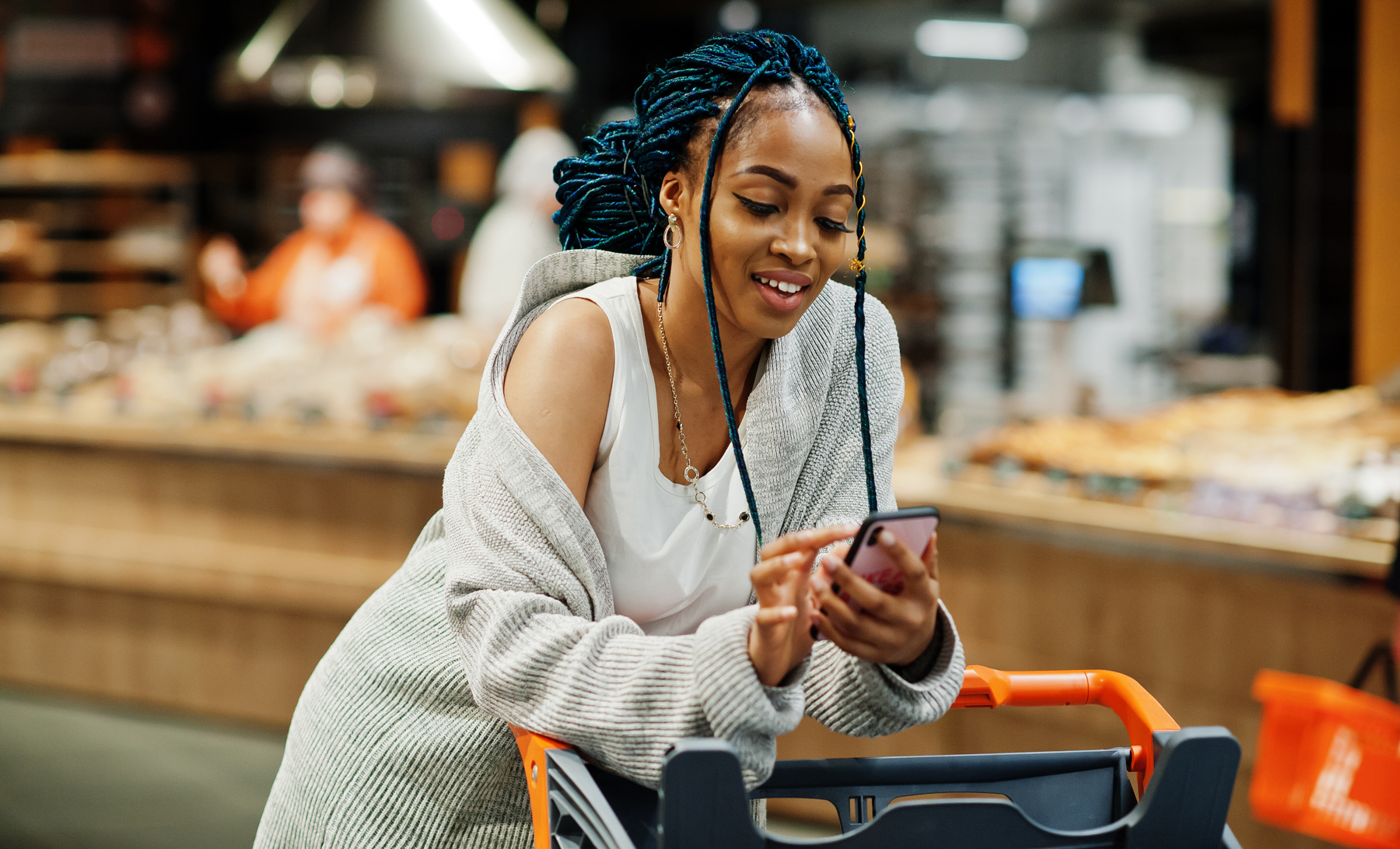 woman in a convenience store on her cell phone