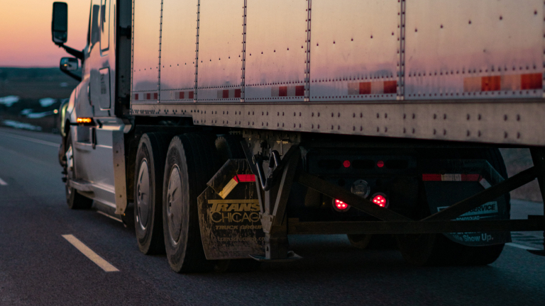 truck driving on the highway at sunset