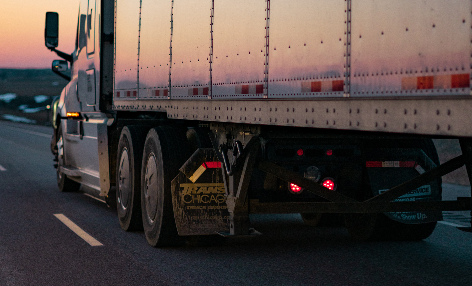 truck driving on the highway at sunset