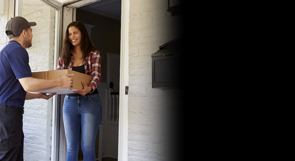 courier delivering a package to a woman