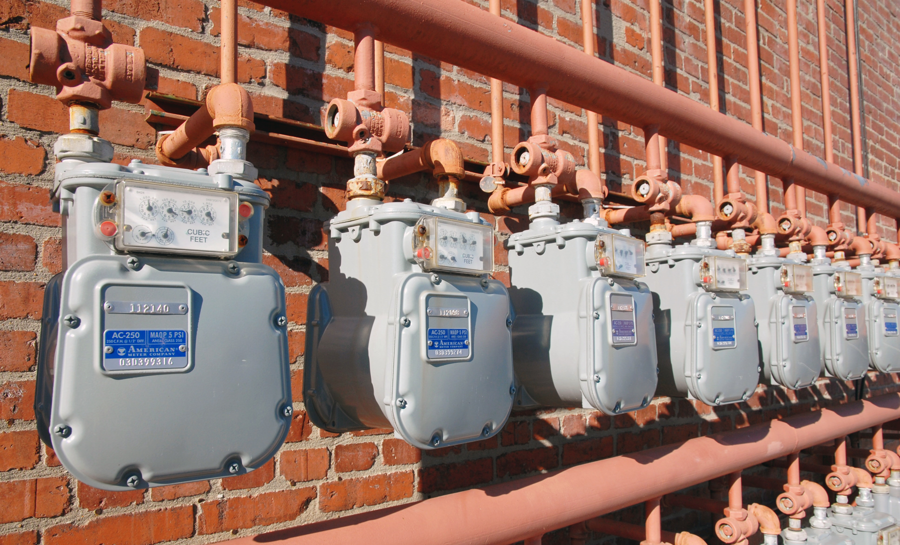 water meters on a brick wall