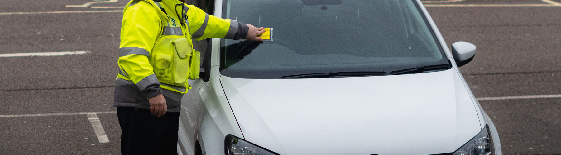 Policeman inspecting a parked vehicle