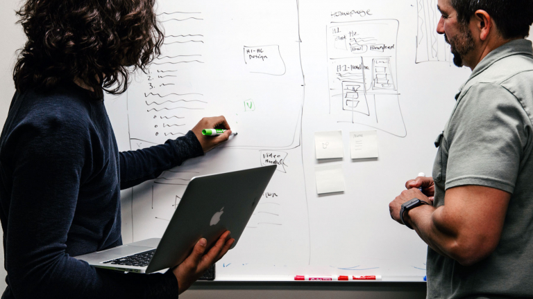 people brainstorming about an app on a whiteboard