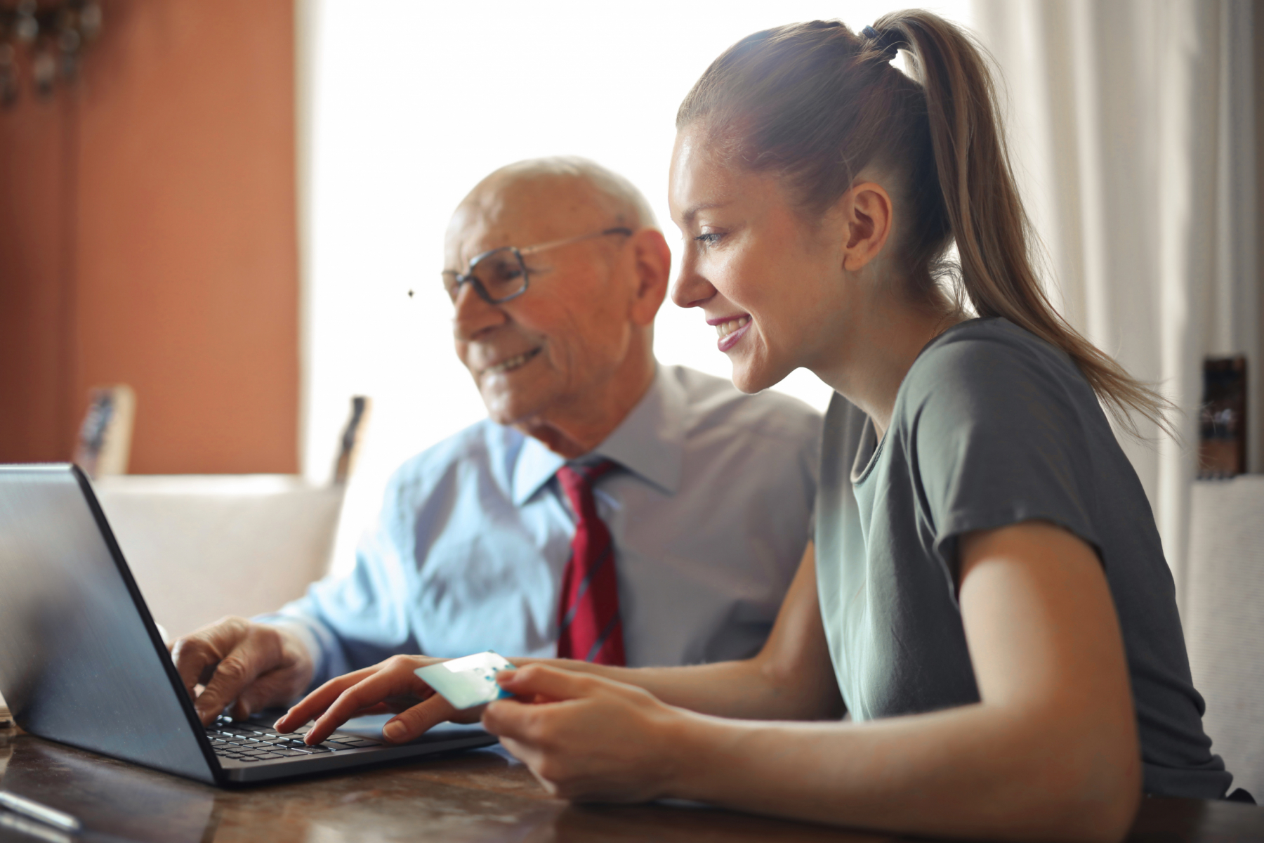 man and woman sitting in front of computer