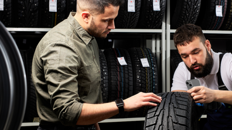 technician measuring tire tread