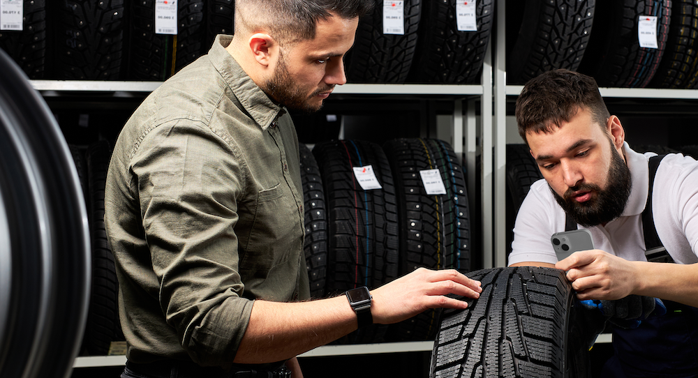 technician measuring tire tread
