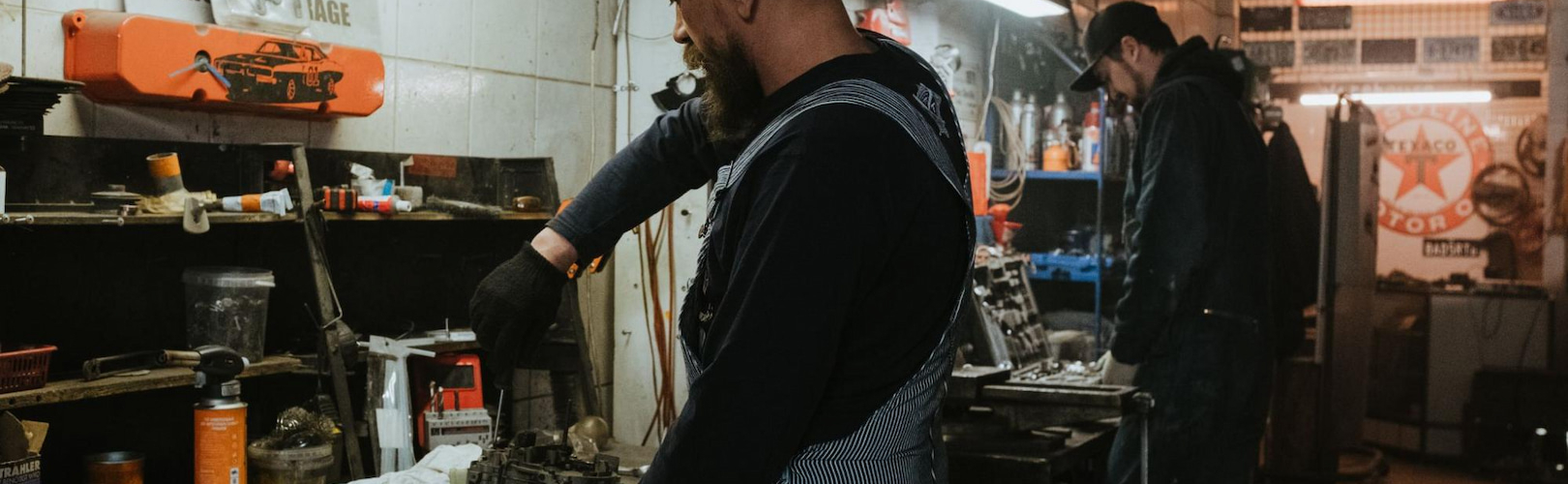 man repairing a vehicle part in a service