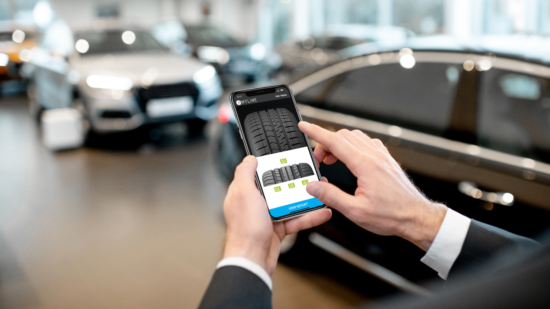 man holding smartphone tire tread on screen