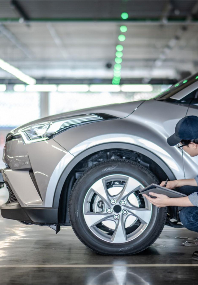 mechanist inspecting car tire