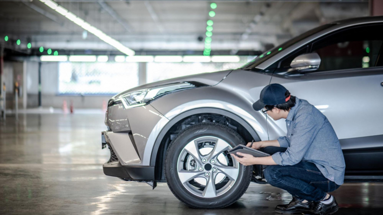 mechanist inspecting car tire