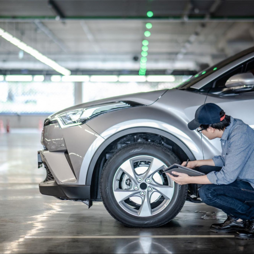 mechanist inspecting car tire