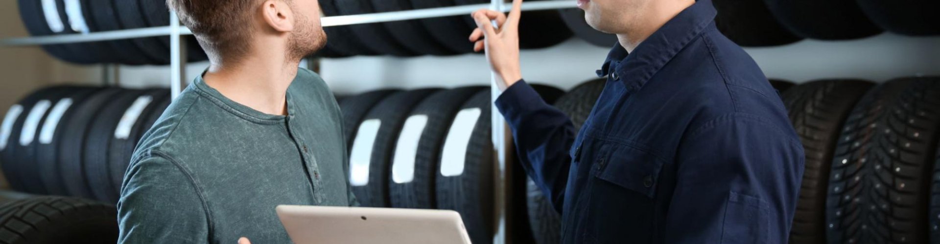 Technician with customer choosing tire for vehicle