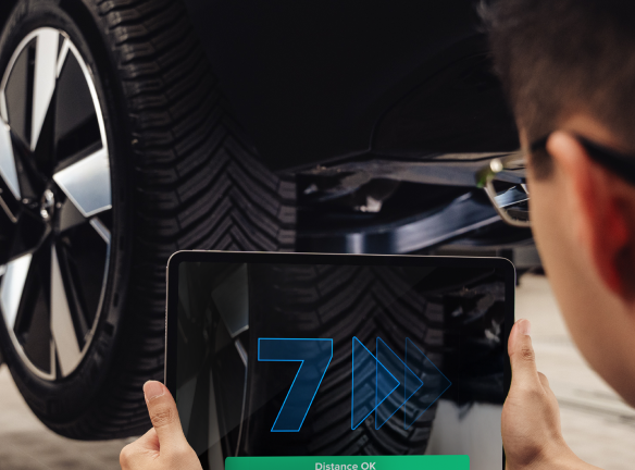Technician scanning a tire tread with a tablet