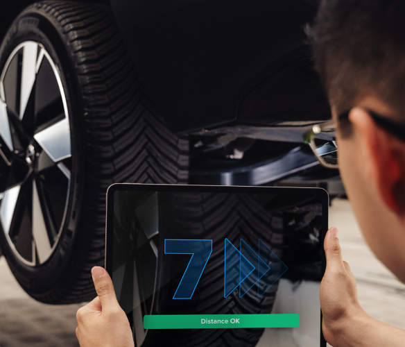 Technician scanning a tire tread with a tablet