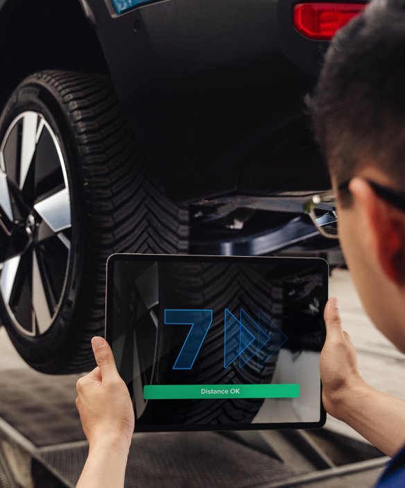 Technician scanning a tire tread with a tablet