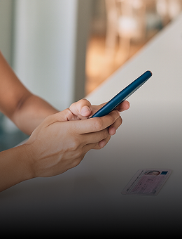 Hands holding a mobile phone scanning a driver´s license