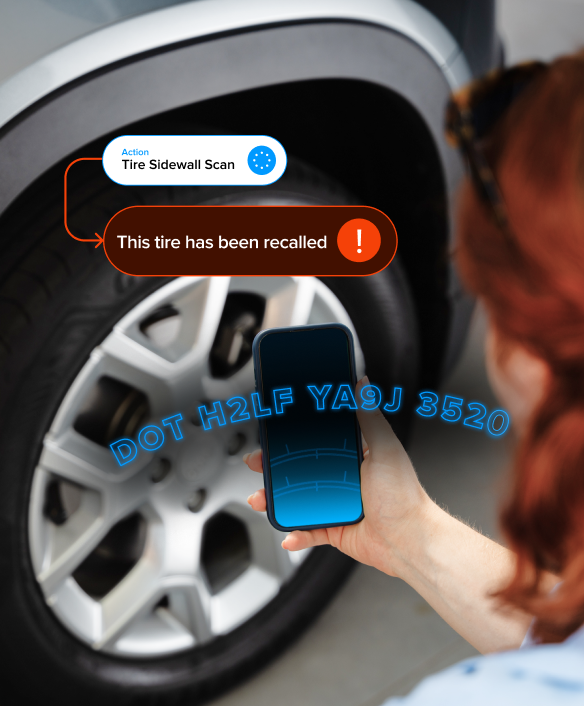 A person scanning tire sidewall information with a smartphone