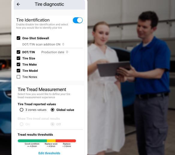 A technician showing a customer the results of a tire inspection on a tablet and visual representation of the data provided